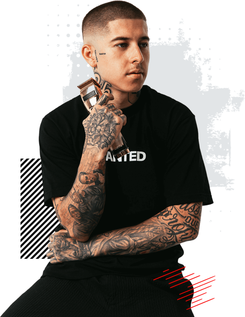 VicBlends sitting in front of a black background showcasing his impressive skills learned at VicBlends, a renowned Barber School.