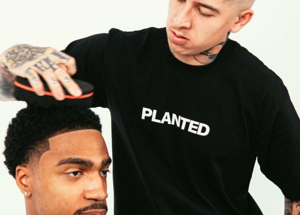 A man is getting his hair cut by VicBlends. A man is getting his hair cut by VicBlends.