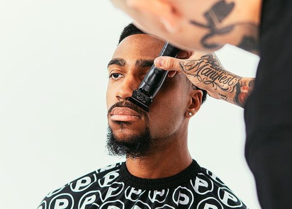 A man getting his hair cut by VicBlends.